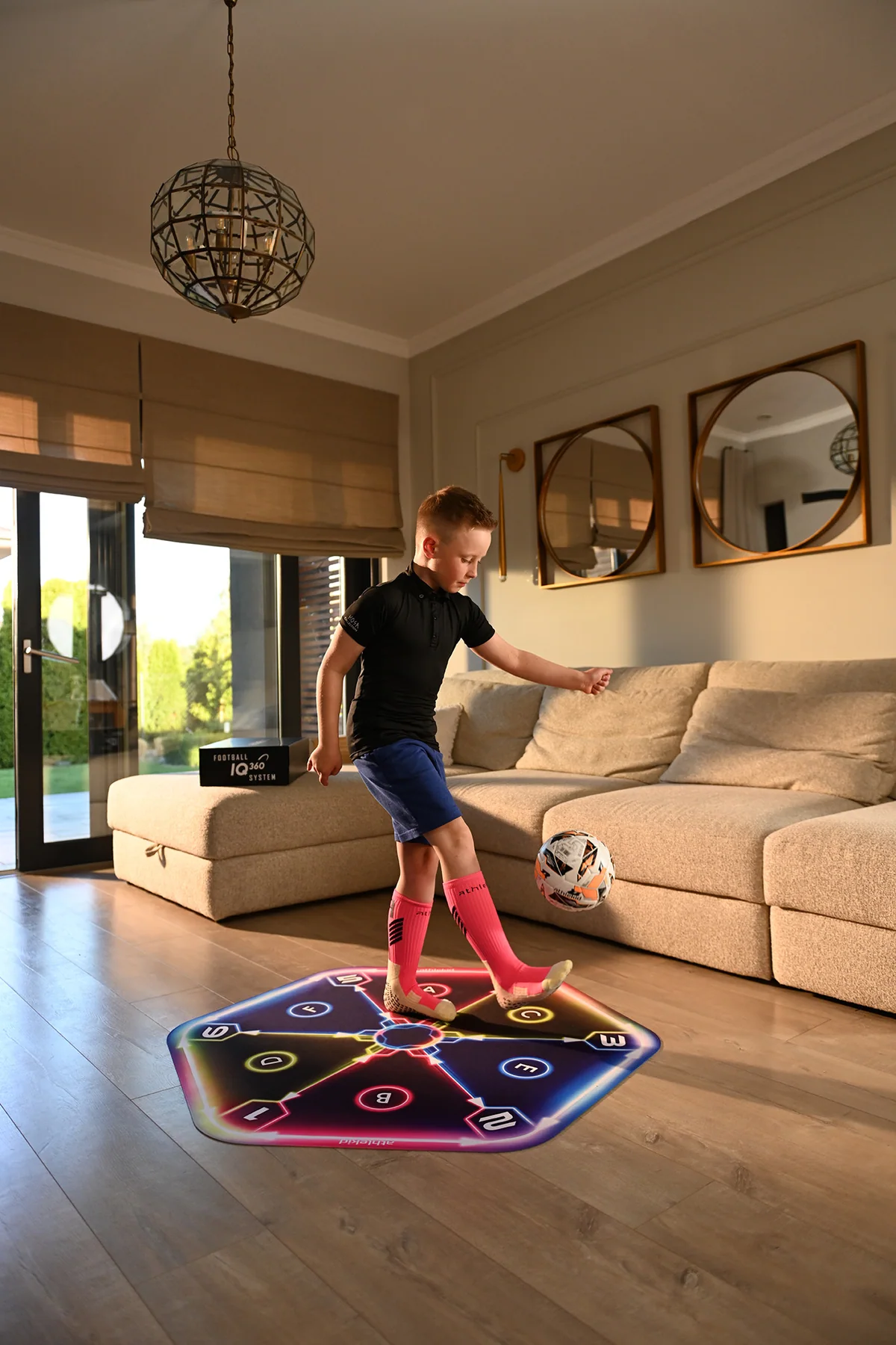 The full Athlekid mat unrolled in a living room with a child training on it